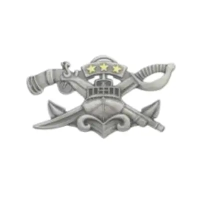 Image of silver Special Warfare Combatant Crew Member Pin. The pin is designed with front of a boat with a six window windshields, has antennas, radar dome with three gold stars, waves are curling up below boat, and from the top left of boat sticks out a flint lock gun. To the right side of boat sticks out a ceremonial sword.